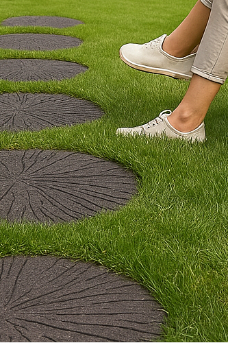 Woman sitting in a chair on a grassy area with stepping stones leading to trees